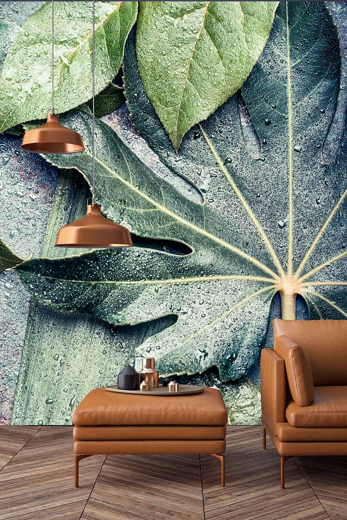 A large botanical mural featuring green and blue leaves adorned with morning dew.