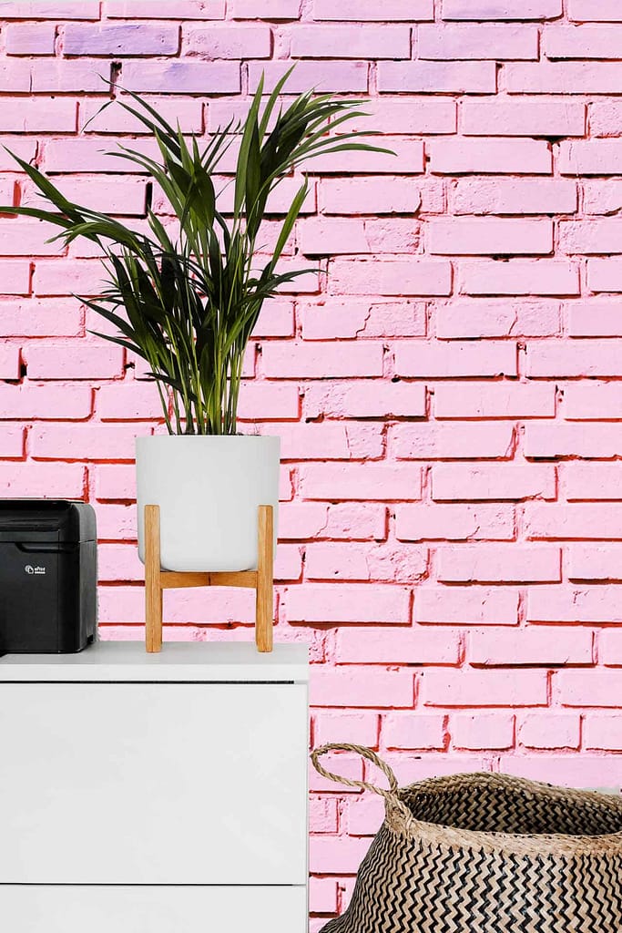 The wallpaper features a pink-painted brick pattern reminiscent of the Pink Panther's signature hue. The color is a distinct and vibrant pink, giving a playful and nostalgic feel to the background.