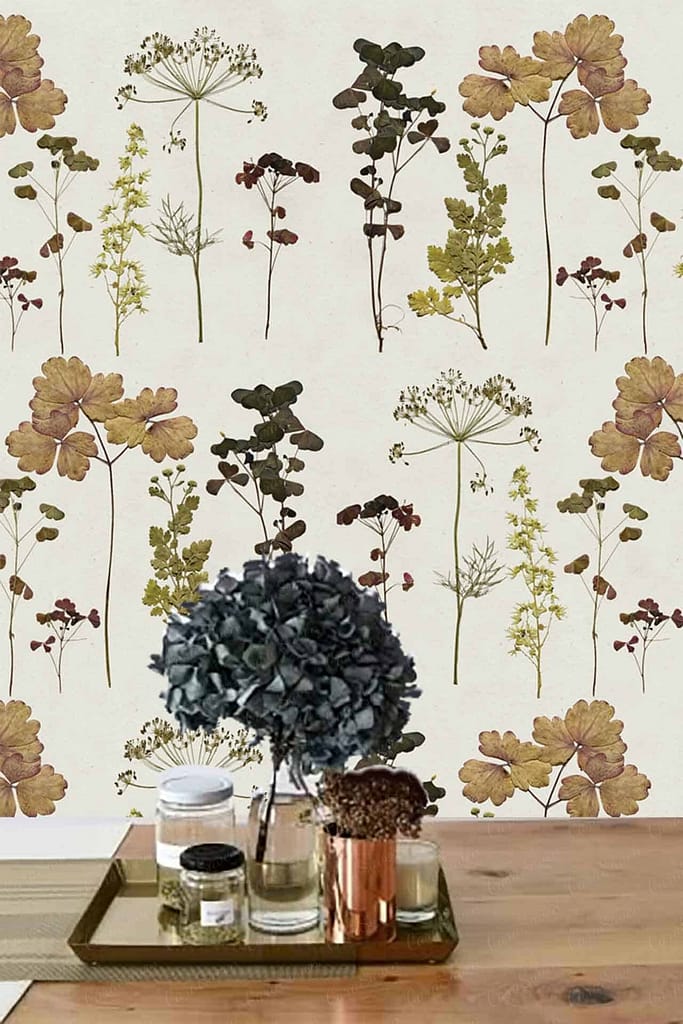 The backdrop wallpaper, "Pressed in Time," is a botanical tapestry featuring various pressed floral and foliage patterns. Delicate petals of charming lavender, blushing pink roses, and sun-kissed daisies intermingle with verdant green ferns and deep emerald ivy. Earthy tones of taupe and muted gold accentuate the natural textures, creating a vintage yet timeless aesthetic that captures the essence of preserved nature.