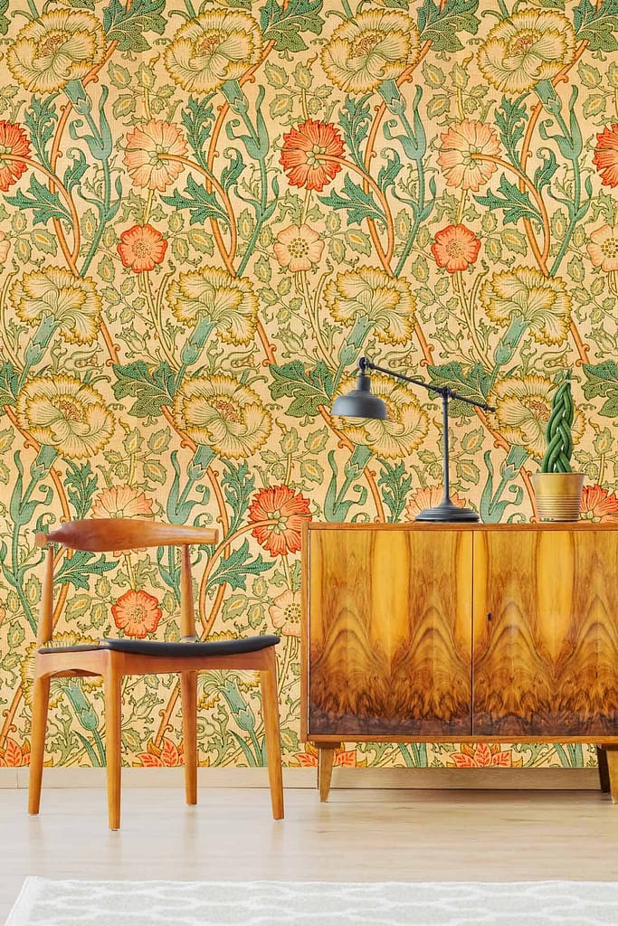 The wallpaper features vibrant, vintage-style floral patterns with bold blooms in shades of orange, red, and yellow. Green leafy accents provide contrast against a soft cream background. Intricate detailing adds to the mid-century charm, evoking the cozy essence of a Swiss Cottage.