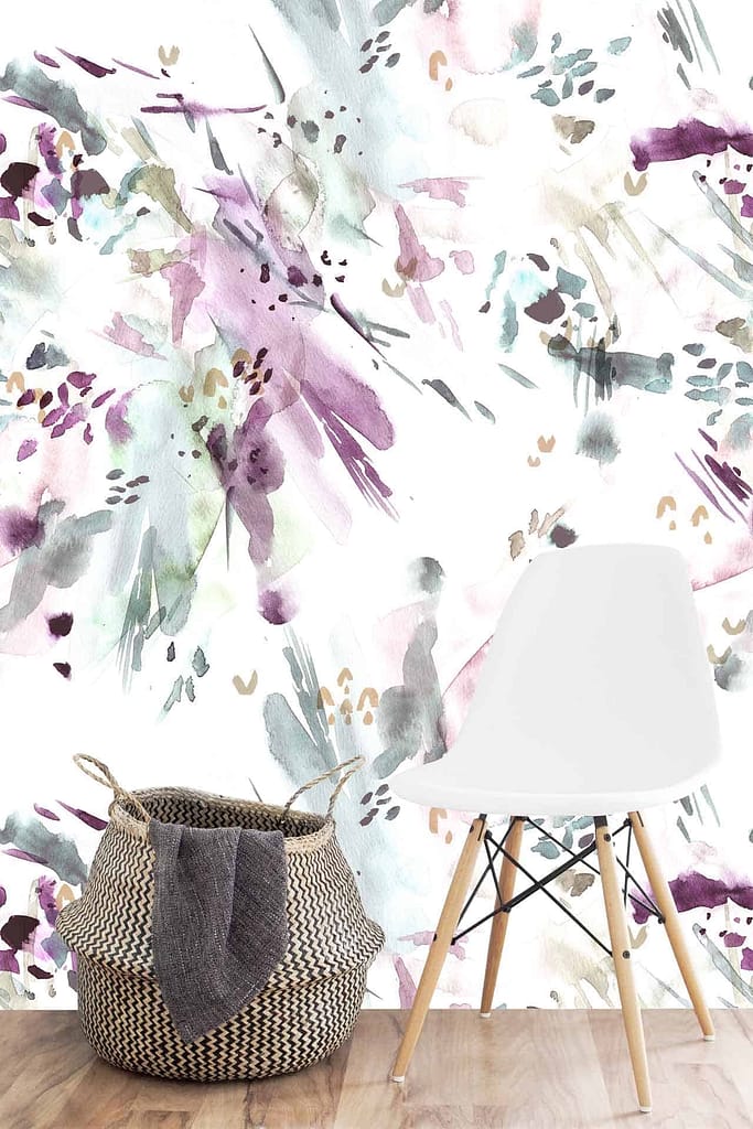 The wallpaper features splashes of purple, green, and beige shades in a watercolor-style abstract mural. Keywords: watercolor-style mural, purple accents, green hues, beige tones.