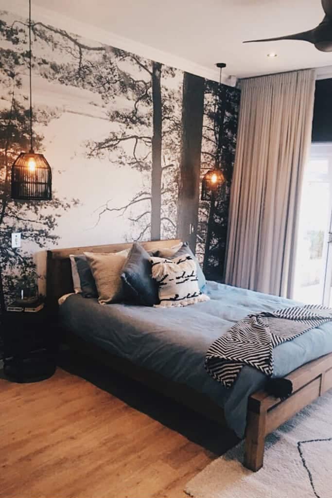 The wallpaper features a serene forest theme, with lush green trees, detailed foliage, and hints of earthy browns. The colors are rich and natural, creating a calming woodland scene.