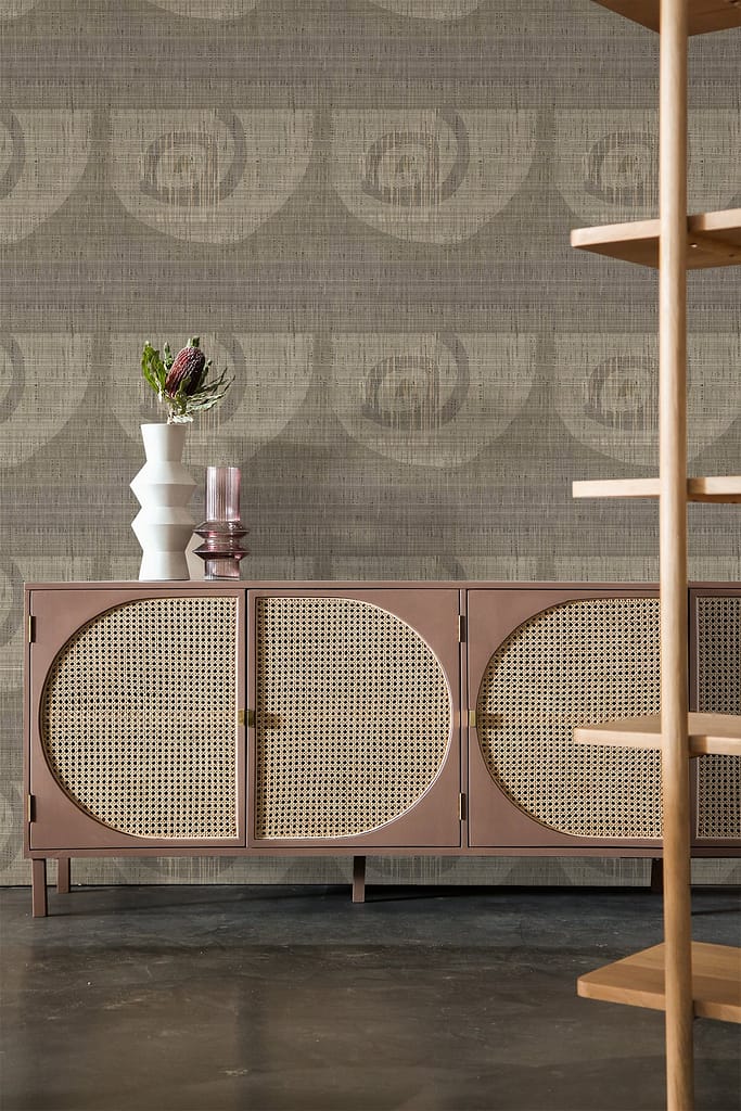 Textured patterned wallpaper featuring subtle geometric shapes and a neutral color palette with shades of beige, cream, and soft earthy tones; intricate textures add depth.