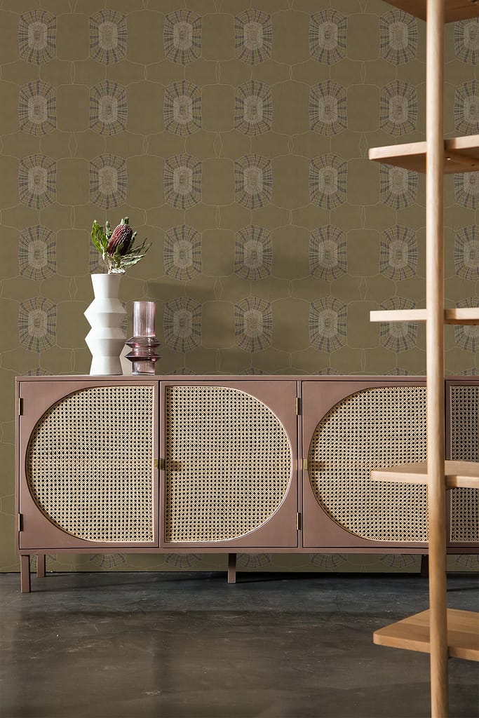 The background features an olive-green patterned wallpaper with intricate designs. The wallpaper's elements include floral motifs and geometric shapes, all in varying shades of green.