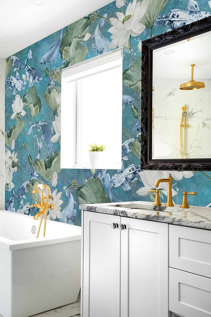 The wallpaper features vibrant blue tones evoking the serenity of a pond, adorned with detailed floral patterns. It showcases shades of deep teal and aquamarine, with pops of gold and white accents embedded in the intricate floral designs. Elements include large water lilies, delicate lotus flowers, and flowing vines that add a natural touch to the modern bathroom setting.