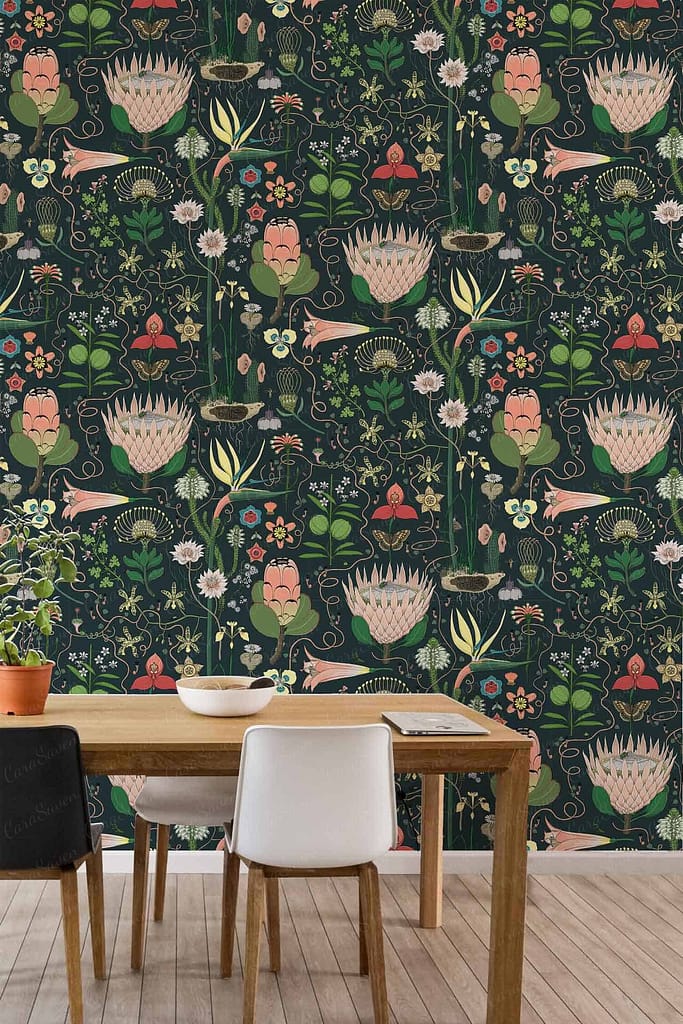 The Modern dining area features Montebello floral-patterned wallpaper characterized by large pink flowers, lush greenery, and small animals, all set against a dark background. The design elements include vibrant pink blooms, varied shades of green foliage, and detailed depictions of petite wildlife, contributing to the rich and dynamic aesthetic.