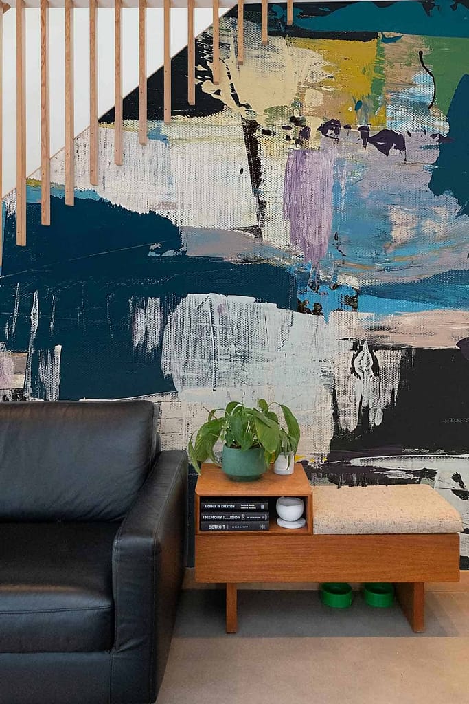 The wallpaper is a bold, abstract mural featuring deep blues, greens, and splashes of purple and white.