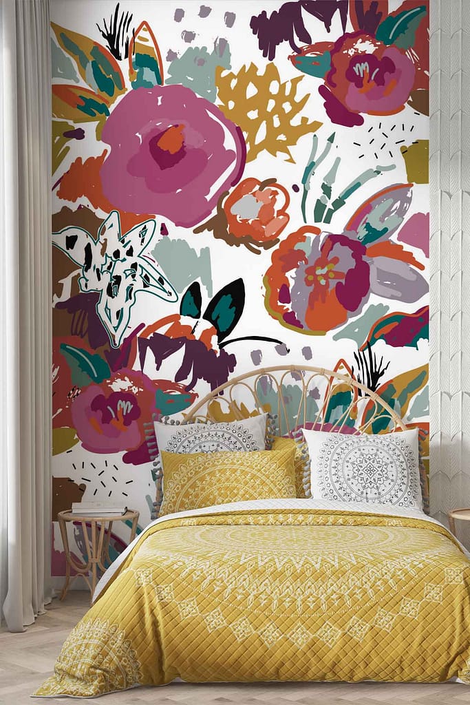 A vibrant bedroom featuring an artistic, multicolored floral mural wall serves as the focal point of this space. The wallpaper bursts with life through a multitude of colors - bold reds, deep blues, lush greens, and sunny yellows intermingle to create a captivating garden-like scene. Each flower is meticulously detailed; rich pink peonies mingle with delicate lavender blooms and striking orange marigolds. Verdant leaves in varying shades of green add depth and contrast to the scene. Splashes of iridescent purples and soft pastels bring complexity to the design. This lively display transforms the room into an enchanting oasis that perfectly embodies the essence of vitality and creativity inherent in Flawless's product line.