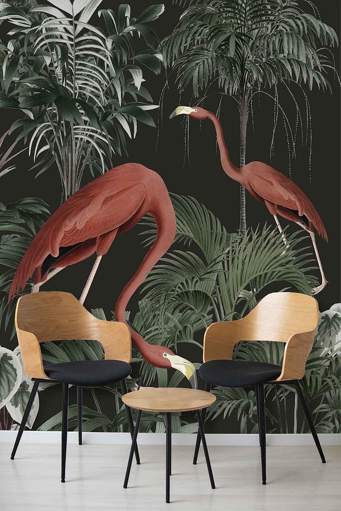 A tropical-themed wall mural features vibrant imagery of two red flamingos set against a backdrop of lush green palm leaves and various foliage. The dominant colors include rich greens from the vegetation and striking reds from the flamingos.