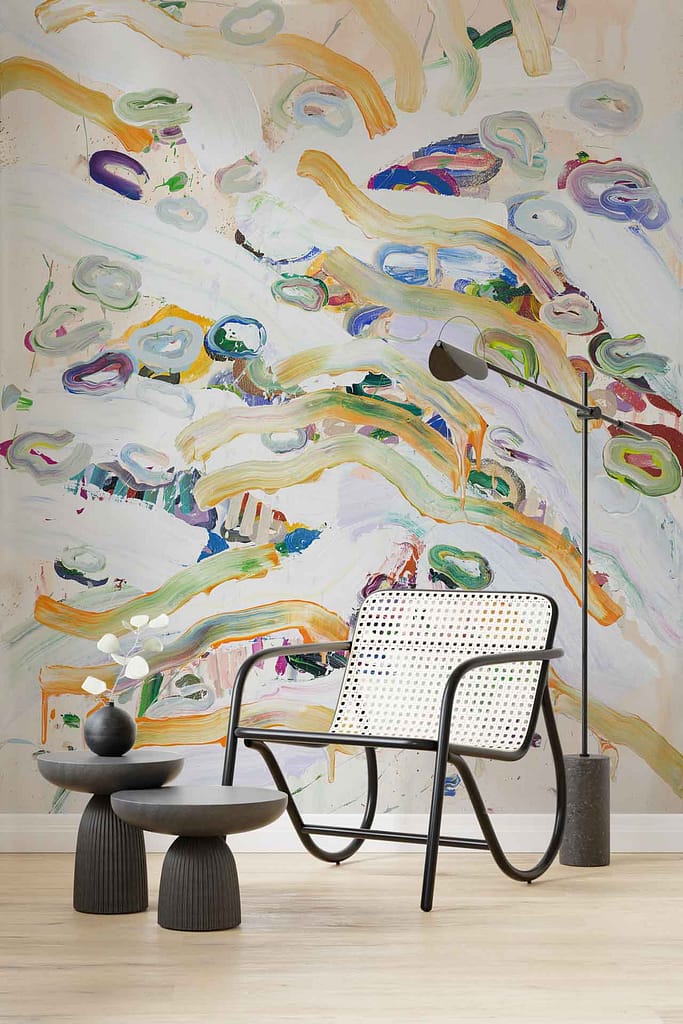 The wallpaper features a dynamic, bold abstract mural with a mix of vibrant and contrasting colors such as deep blues, bright reds, mustard yellows, and crisp whites. The elements include sweeping strokes, geometric shapes, and fluid patterns that create a visually stimulating backdrop.