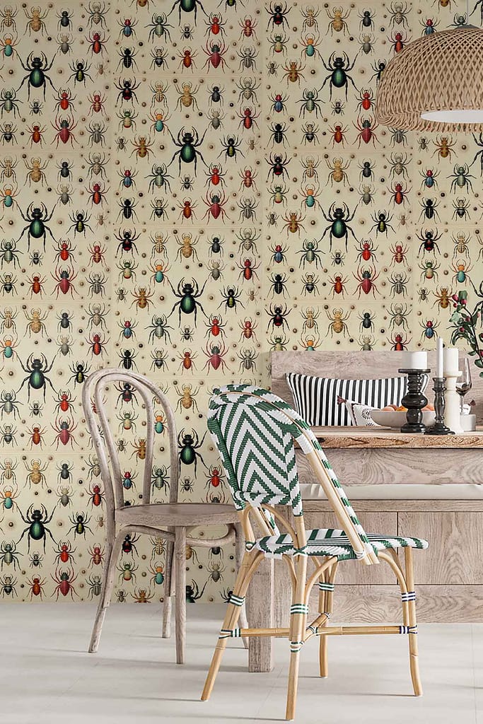 The wallpaper in the dining room is a patterned design featuring various insects, including ants and beetles. The colors prominently displayed are red, black, and green against a beige background.