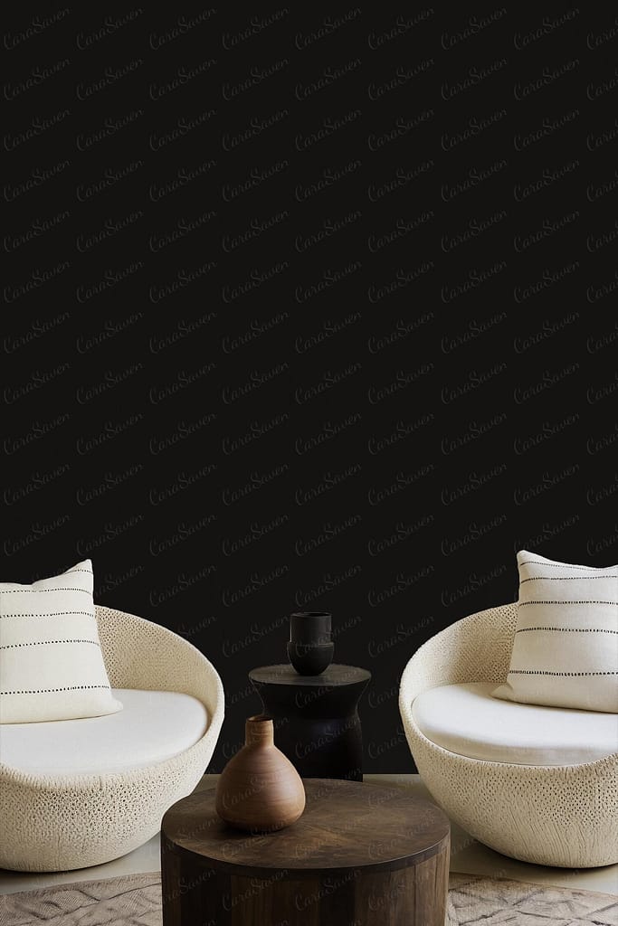The wallpaper features a dark, textured background with subtle patterns in deep charcoal and hints of muted graphite. This minimalistic design adds depth to the room while ensuring the cream-colored lounge chairs and wooden elements stand out.