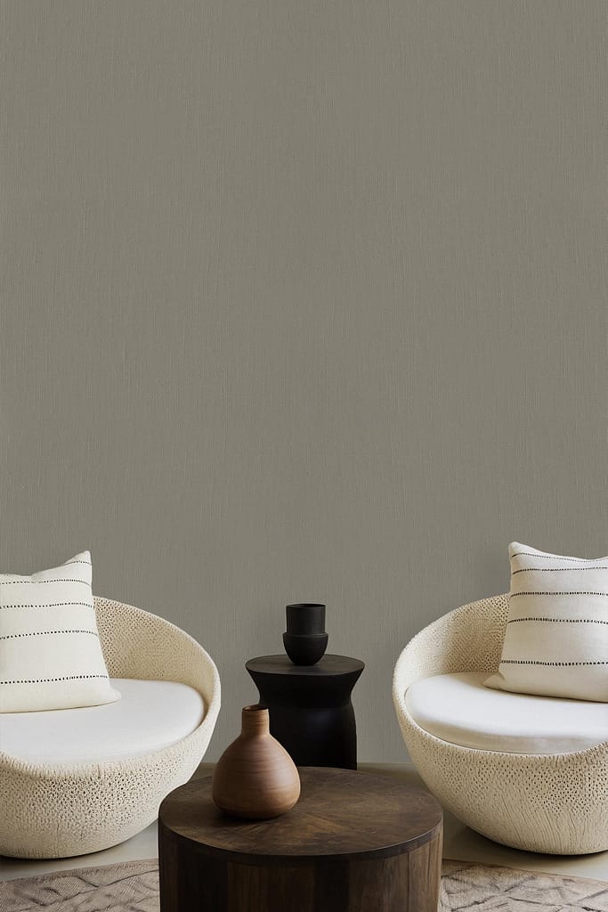 The wallpaper is a soothing gray, creating a minimalist backdrop with subtle sophistication. The neutral tone exudes calm and complements the modern décor elements in the room.