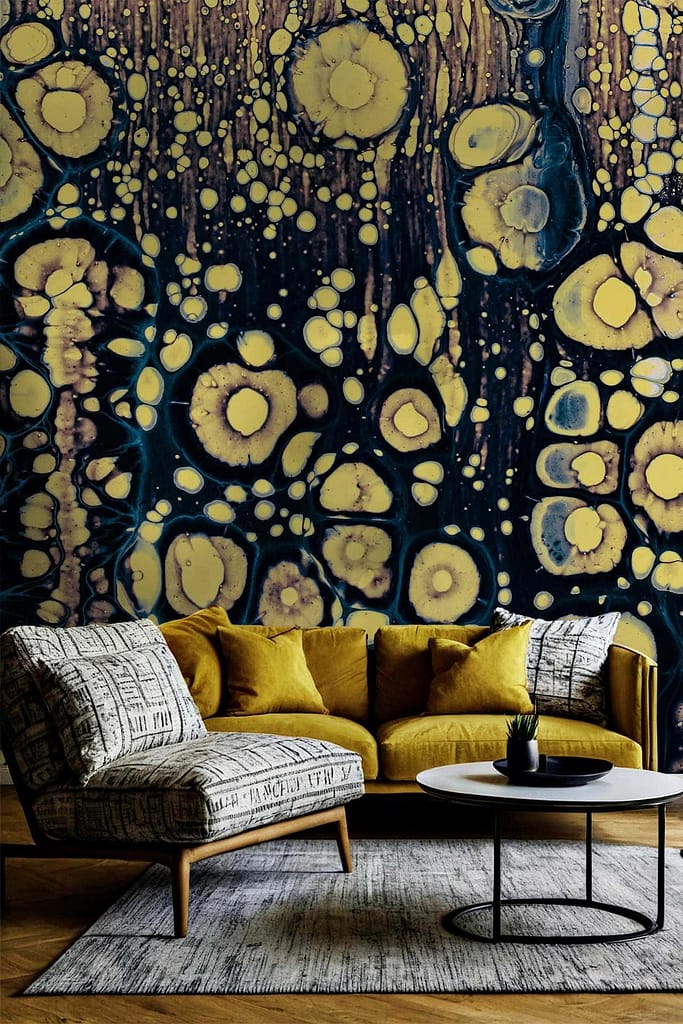 Abstract mural wallpaper featuring bold circular patterns in mustard yellow and dark blue, with a marbled effect resembling tropical beauty.