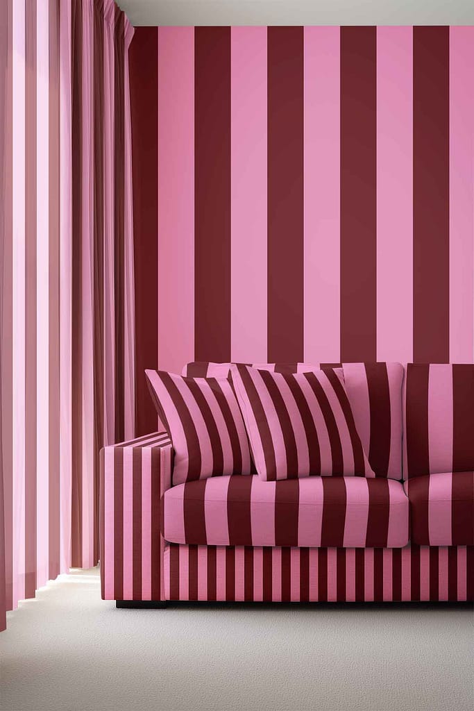Wallpaper with bold pink and maroon vertical stripes, creating a striking, eye-catching pattern. The colors alternate evenly for a dramatic effect.