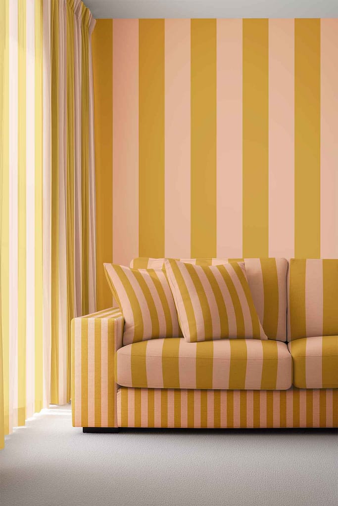 Striped wallpaper in yellow and pink tones, creating a vibrant pattern on the living room walls. The colored stripes are bold and distinct, making the wallpaper a standout feature in this space.