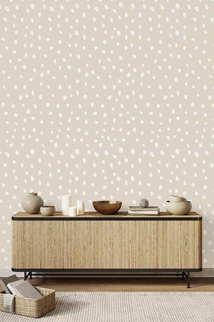Beige wallpaper featuring an irregular white polka dot pattern.