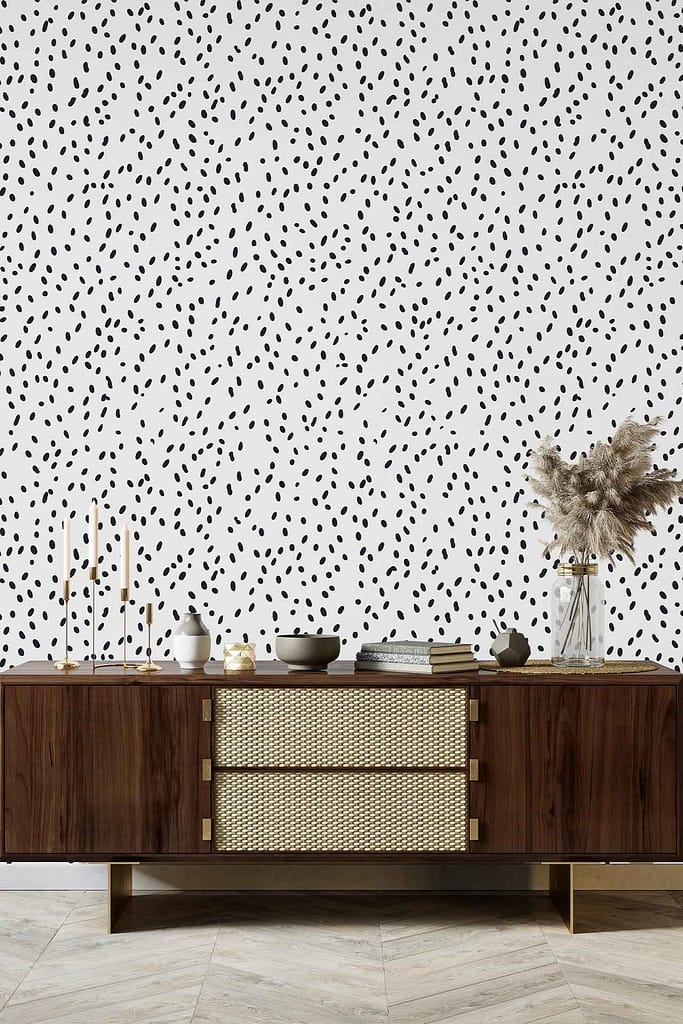 White wall featuring a bold black irregular polka dot wallpaper pattern. High contrast and playful black spots stand out against the crisp white background, making the wallpaper visually distinctive.