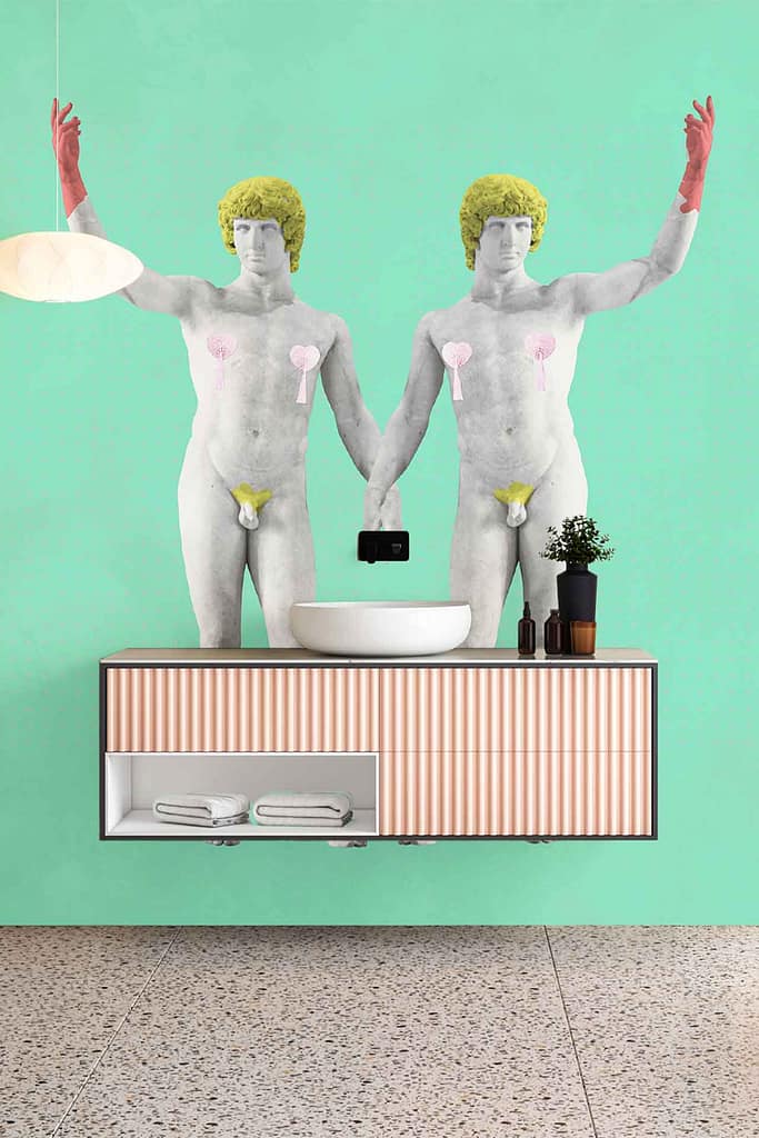 Pastel green wallpaper forms the bathroom's backdrop, featuring mirrored, stylized nude male figures with yellow hair, red gloves, and cartoon hearts—creating an eye-catching pattern.