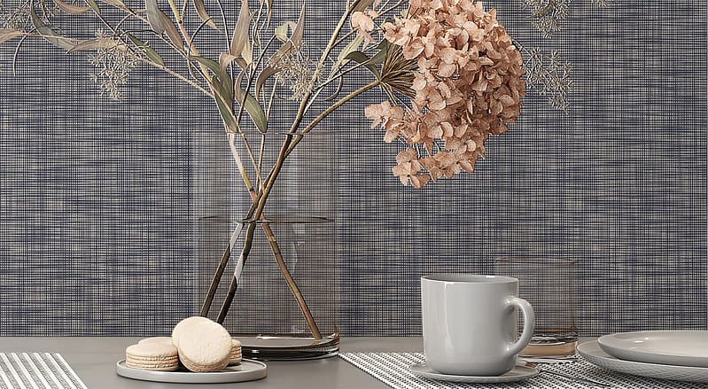 Textured blue-gray wallpaper with subtle patterns and a muted, cool-toned color palette.