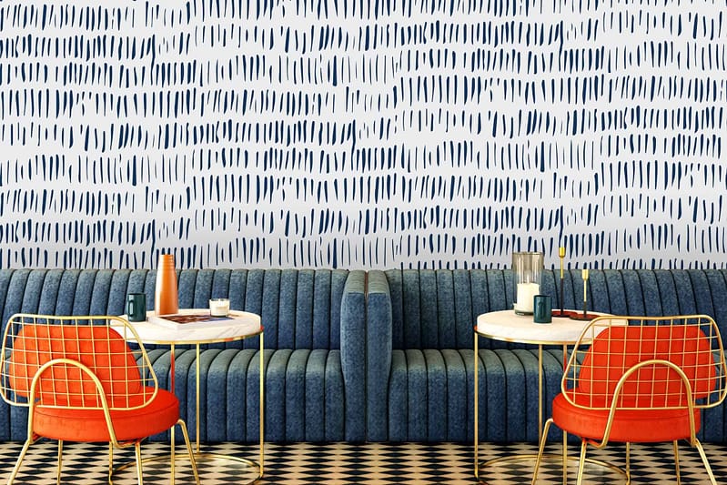 The wallpaper at Cafe Lello features a chic blue pattern. Elements include intricate designs and motifs in varying shades of blue.