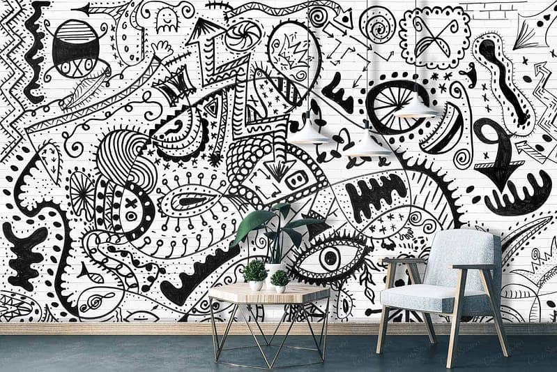The living room's white wall is a canvas of intricate black doodles and abstract designs, embodying the theme *making your mark*. The wallpaper features detailed line art, geometric shapes, swirling patterns, and unique motifs in stark black against a pristine white background.