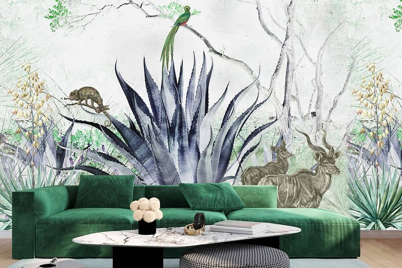 The wallpaper in the living room features a striking tropical-themed mural with a vibrant agave plant, two graceful antelopes, a colorful parrot, and a camouflaged chameleon. The lush green tones of the agave blend seamlessly with the detailed fur patterns of the tan and brown antelopes. Bright splashes of blue, yellow, and red highlight the parrot perched amidst foliage. The chameleon displays shifting hues of green and subtle hints of orange to blend into its surroundings. This eclectic mix of exotic fauna against rich botanical elements brings an air of wild elegance to the room's decor.