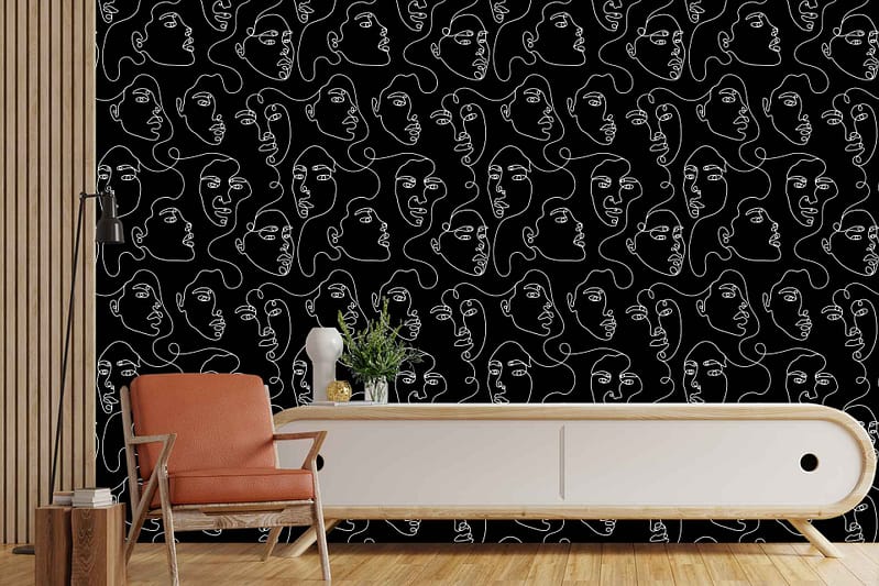 The wallpaper features a black accent color showcasing an intricate, abstract continuous line drawing titled "A Thousand Faces." The left wall highlights vertical wooden slats, adding texture and depth. Key elements include the black background and white line art, creating a striking contrast that stands out in the room.