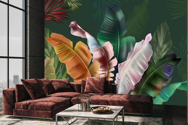 The wallpaper features a large, colorful mural of tropical leaves on a dark green background. It showcases vibrant greens, rich oranges, and hints of deep blues, bringing an exotic and lively feel to the living room.