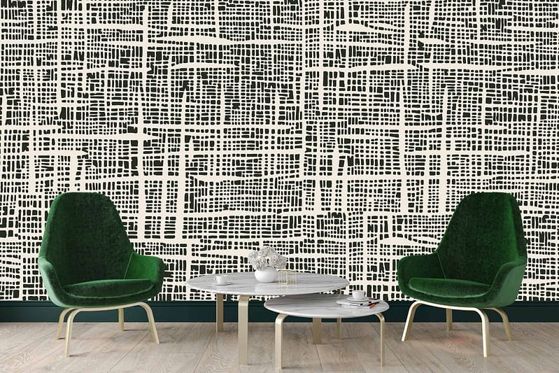 A modern living room features a striking black and white geometric patterned wall. Elements include bold, intertwining lines and shapes that create an eye-catching contrast. The wallpaper's colors are limited to black and white, enhancing its contemporary look. Ideal for those searching for monochrome, geometric designs.