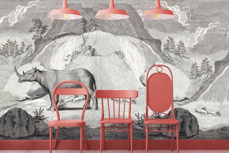 Wallpaper featuring a mural of an extinct rhinoceros set against a mountainous landscape. Dominated by shades of grey and pink, this design includes intricate details of the rhinoceros and mountain textures. Pink hues are woven subtly into the landscape elements, emphasizing a monochromatic palette with stylish pink accents.
