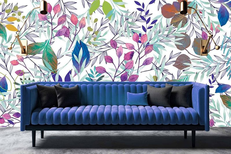 A stylish room showcases a vibrant leaf-patterned wallpaper featuring various shades of green, purple, and pink.