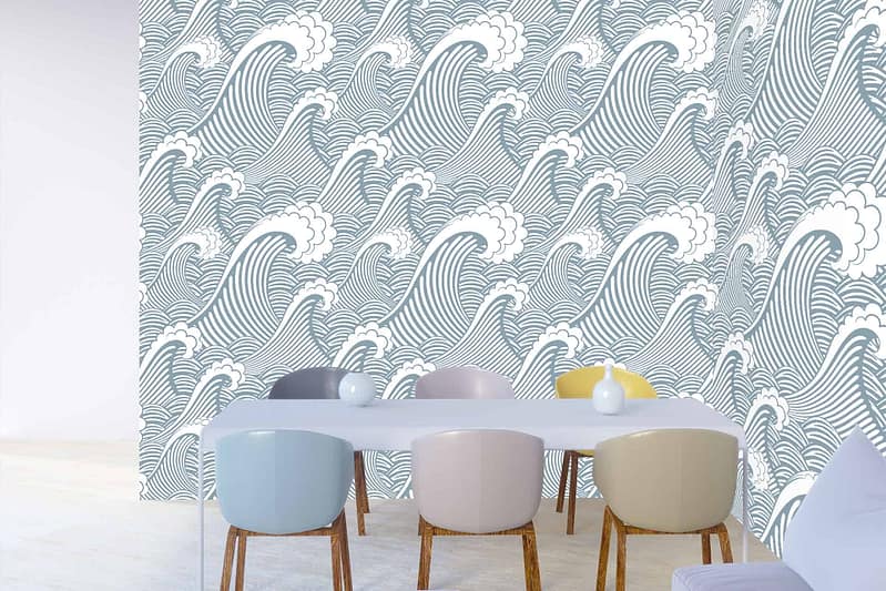The wallpaper features bold, stylized ocean waves in shades of blue and white. The design evokes vibrant coastal energy, creating a striking visual effect. Elements: ocean waves, stylized design. Colors: multiple shades of blue, white.