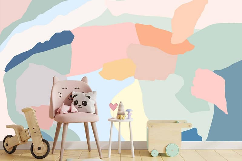 Jamie's whimsical children's room features a **pastel abstract mural wall**. The wallpaper includes soft shades of pink, mint green, lavender, and light blue with playful, flowing shapes and delicate patterns. This dreamy mural sets a gentle and imaginative backdrop for the room’s decor.