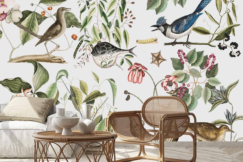 The wallpaper in the stylish living area showcases an enchanting mix of birds and botanical illustrations, featuring vibrant hues of deep green foliage, colorful birds like parrots and finches with striking reds, blues, yellows, and subtle earth tones. Delicate flowers in shades of pink and white intermingle with intricate leaves and vines. The nature-inspired art on the wallpaper serves as a dynamic backdrop that celebrates creatures great and small while blending seamlessly with modern decor elements.