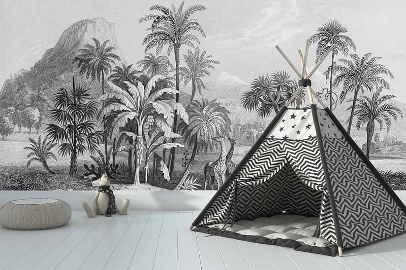 The wallpaper features a tropical jungle scene with elements such as lush green palm trees, intricate foliage, and majestic mountains. The color palette includes various shades of green for the vegetation, earthy browns for tree trunks, and subtle grayish-blue tones for the mountains. This nature-inspired mural creates a soothing and immersive atmosphere in the room.