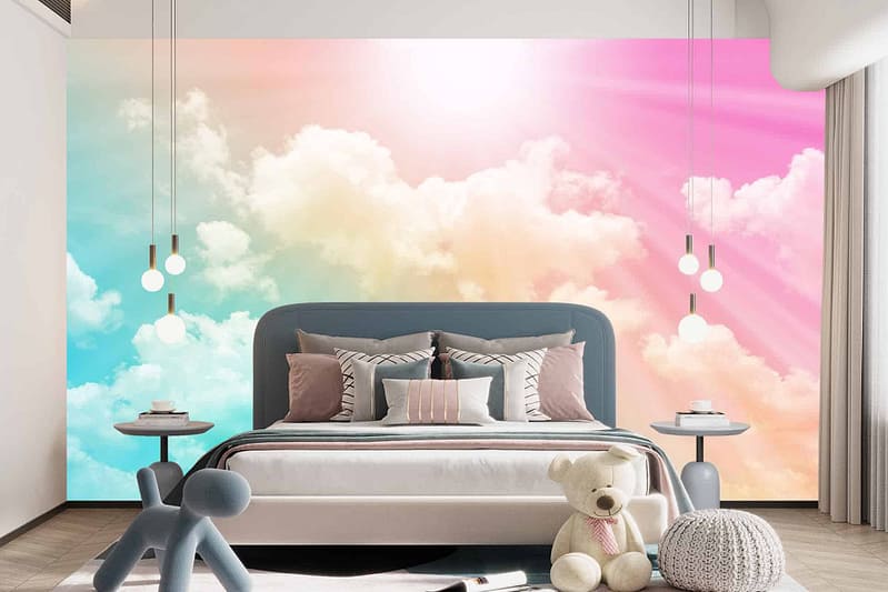 A dreamy mural of clouds in blue, pink, and peach hues covers the wall.