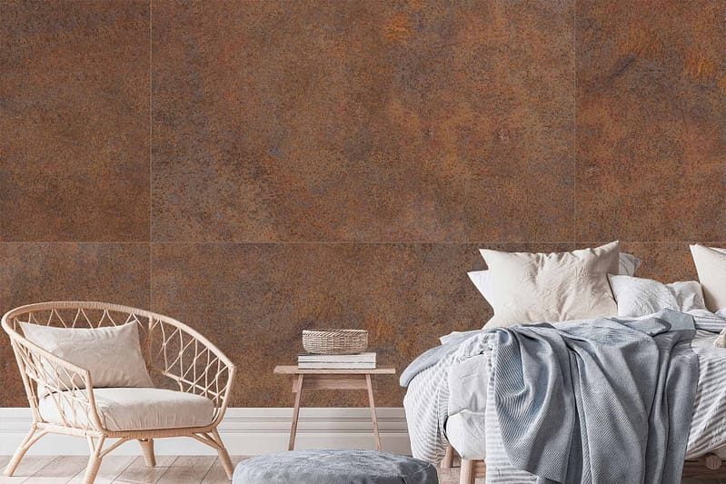 The bedroom features a wall with a rusty, large-tile wallpaper. The tiles showcase varying hues of rust and earthy tones, giving the room a warm and textured backdrop.