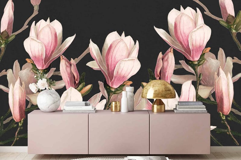 A chic living room features dark floral wallpaper adorned with large magnolia blooms in soft pink and white hues.