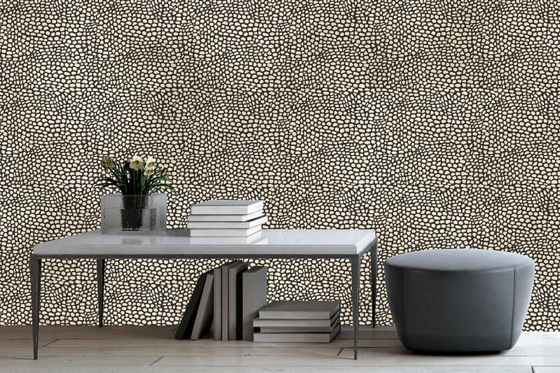 Textured wallpaper featuring a pebble-patterned design in neutral tones. The pattern resembles the scales of a serpent with hues of gray, beige, and off-white.