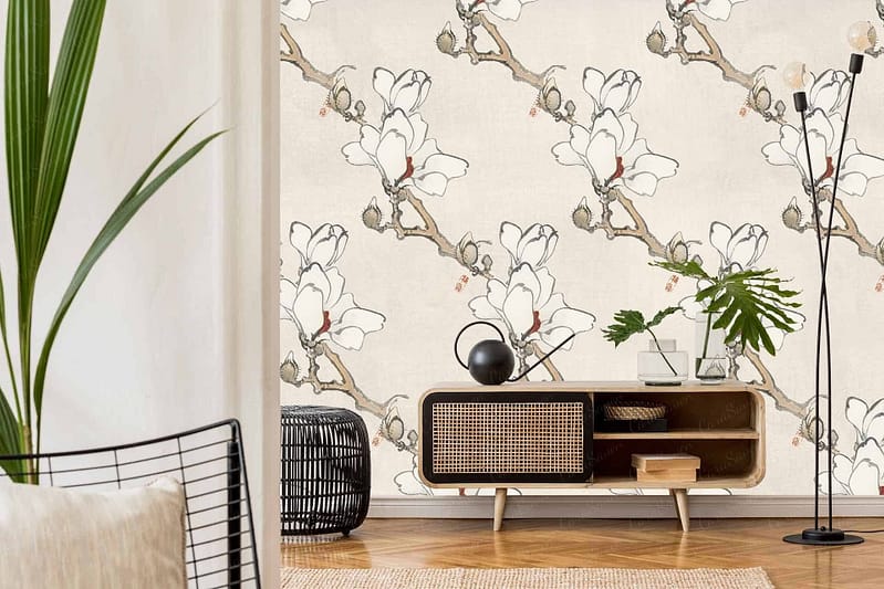 A stylish living room features light-colored floral wallpaper with large white flowers and branches reminiscent of *Steel Magnolias*.