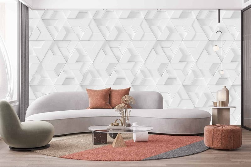 The modern living room features a white geometric Wonderwall wallpaper. The wallpaper's design showcases intricate patterns with sharp angles and clean lines in pure white hues. This sleek and contemporary backdrop adds a sophisticated touch to the room's ambiance, perfectly complementing the overall decor with its minimalist elegance.
