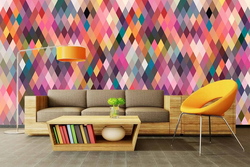 The wallpaper features a vibrant, multicolored diamond pattern. It consists of bold, interlocking diamonds in hues like red, orange, yellow, green, blue, and purple. The colors are vivid and create an eye-catching backdrop with a modern geometric design.