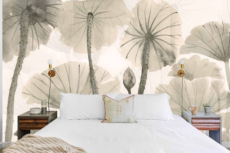 A bedroom wallpaper featuring large gray-green leaves. The mural highlights an intricate design with varying shades of gray and green, creating a lush, serene backdrop that adds depth and elegance to the room.