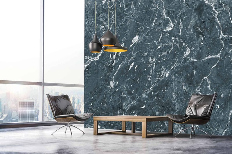 The wallpaper in this modern minimalist living room is a captivating dark marble accent with striking white veining. The deep, rich hues of the dark marble provide an elegant backdrop, while the intricate white veins add contrast and sophistication. This refined design perfectly complements the room's black leather chairs, wooden coffee table, and sleek black pendant lights—all set against the impressive floor-to-ceiling window showcasing a stunning cityscape view.