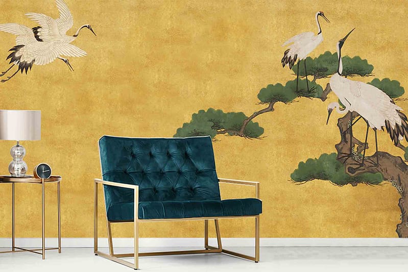 Yellow wall mural, elegant cranes, tree branches, reminiscent of Asian Nights.