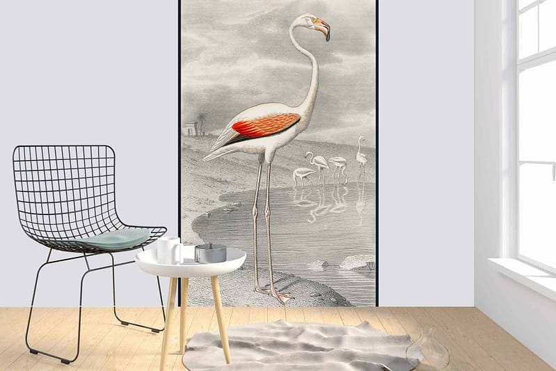 A Minimalist room with a white wall features a large, vibrant illustration of flamingos by water. The wallpaper showcases soft pink and coral hues of the flamingos, contrasting with the blue and green tones of the water and surrounding foliage. Splashes of gentle pastels evoke a romantic "Be My Valentine" feeling, creating an eye-catching focal point in an otherwise serene space.