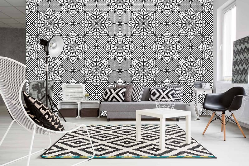 The accent wall in the modern living room features a bold monochrome geometric theme, dominated by black and white patterns. Triangles, squares, and intricate shapes interlock seamlessly in contrasting shades of deep black and crisp white. This eye-catching wallpaper serves as the room's focal point, drawing attention with its striking black lines against a pure white background. Key elements: monochrome geometric theme, black patterns