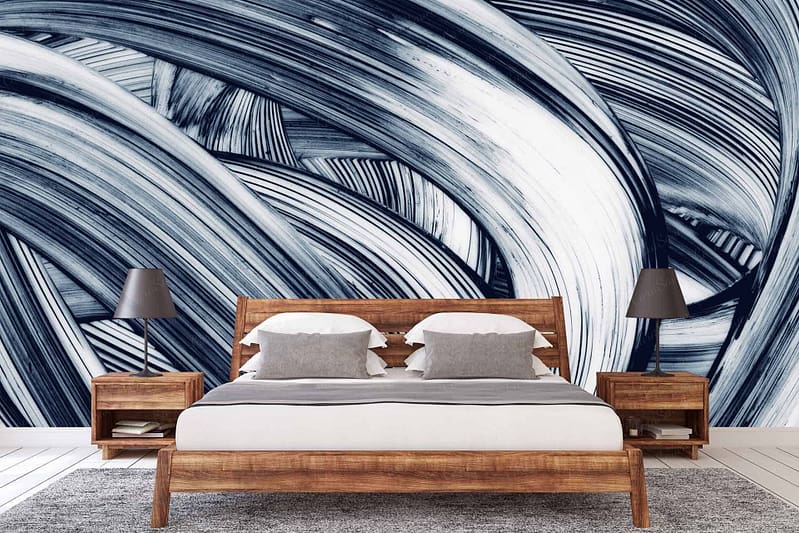 The wallpaper is a large, abstract mural featuring broad strokes of blue and white. It serves as the background of the modern bedroom, providing a striking, artistic backdrop. The bold blue and white patterns create dynamic visual interest.