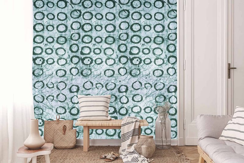 The wallpaper in the cozy living room features a unique pattern with blue and white circular designs. The elements include circular shapes, primarily in shades of blue and white.